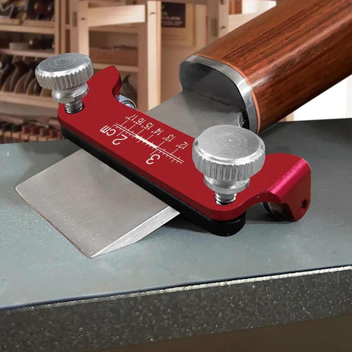 Guide d'affûtage rouge en aluminium avec un ciseau à bois serré dedans